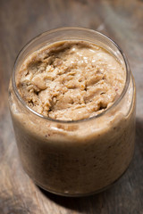 homemade peanut butter in a jar, vertical