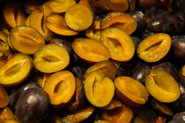 Preparation for the production of jam. Halves of plums without seeds.