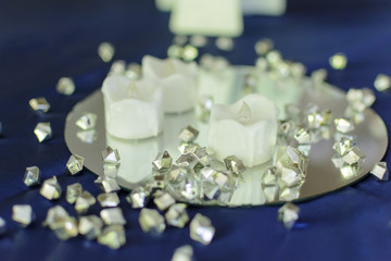 diamond decoration on a wedding table with candle and mirror.