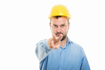 Young architect with yellow helmet showing watching you gesture