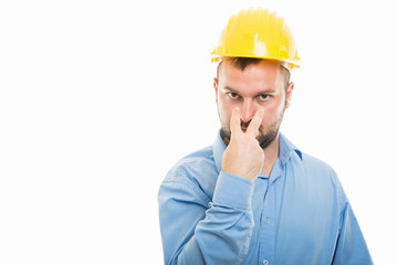 Architect with yellow helmet showing look into my eyes gesture