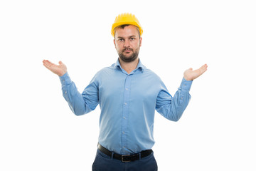 Young architect with yellow helmet showing don't know gesture