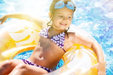 Beautiful girls at swimming pool in summer time