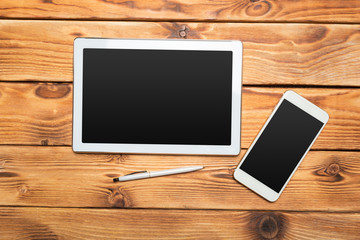 White digital tablet on wooden table