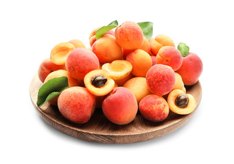 Plate with ripe sweet apricots on white background
