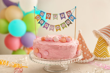 Stand with beautiful tasty birthday cake on table © Pixel-Shot