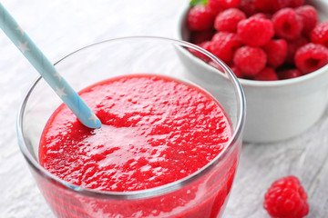 Glass of tasty raspberry smoothie, closeup