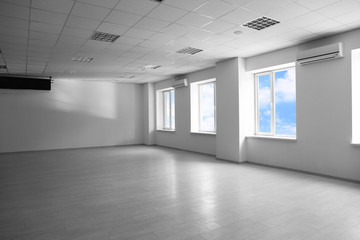 Empty spacious room with big windows