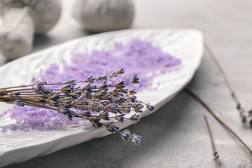 Obraz na płótnie Canvas Plate with sea salt for spa and lavender on table, closeup