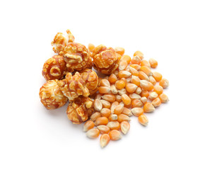 Delicious popcorn and kernels on white background