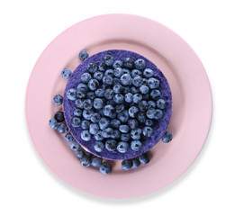 Plate with delicious blueberry cheesecake on white background, top view