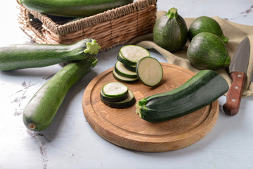 Board with ripe cut zucchini on light table