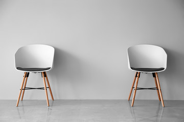 Comfortable chairs near light wall
