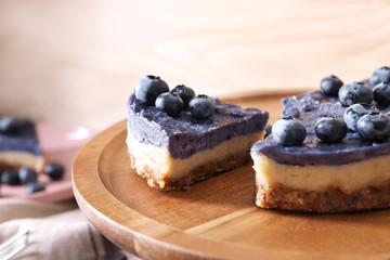 Stand with tasty blueberry  cheesecake, closeup
