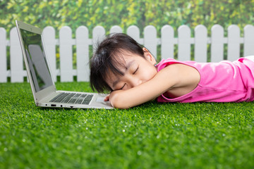 Asian Little Chinese girl playing with laptop