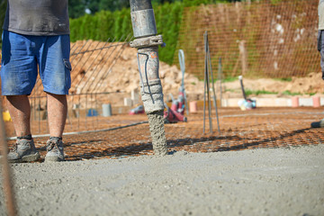 Concrete pouring during commercial concreting floors of building