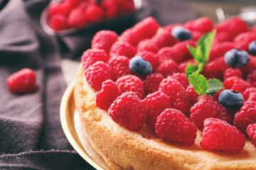 Delicious raspberry cheesecake on table, closeup