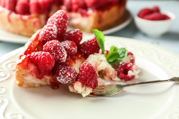 Piece of delicious raspberry cheesecake on plate, closeup