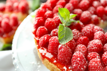 Delicious raspberry cheesecake on dessert stand, closeup
