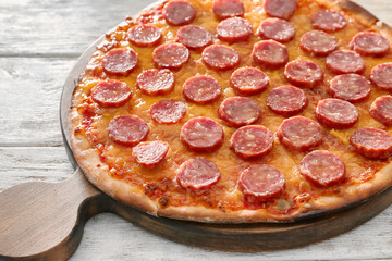 Tasty Pepperoni pizza on wooden table, closeup