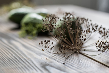 Fresh green cucumber with flowering dill on a wooden background