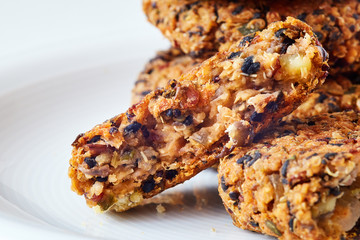 Vegan quinoa and bean burgers made with beans, quinoa, nori algae, oats, smoked peppers and onions on white background