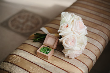 wedding day. bouquet and gold rings. detail