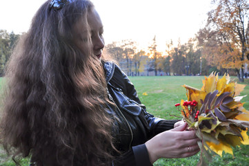 Woman collects autumn bouquet. Golden autumn in Tsaritsyno, Russia, Europe