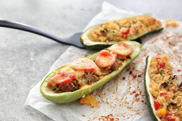 Meat and quinoa stuffed zucchini boats on light table