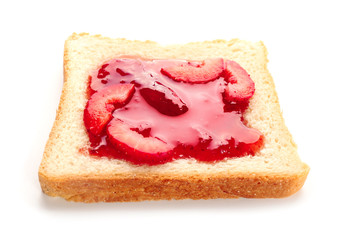 Slice of bread with delicious strawberry jam on white background
