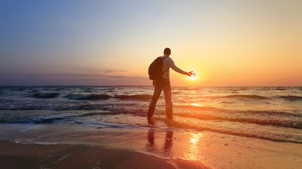 Fototapeta na wymiar silhouette of a man at dawn / beach wilderness dawn