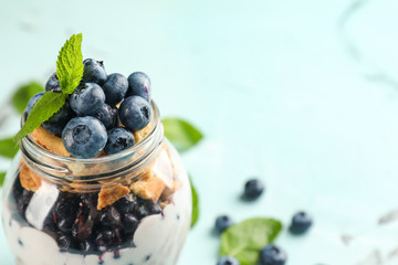 Glass jar with delicious blueberry dessert, closeup
