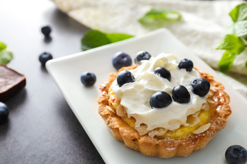 Delicious blueberry tart on plate, closeup