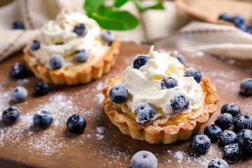 Delicious blueberry tarts on board, closeup