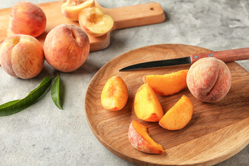 Plate with fresh peaches on light table