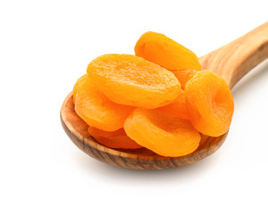 Fototapeta na wymiar Spoon with dried apricots on white background