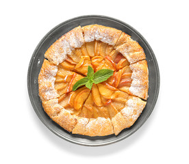 Plate with delicious peach galette on white background