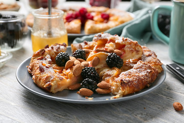 Plate with delicious peach galette on light table