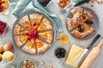 Composition with delicious peach galette on light table