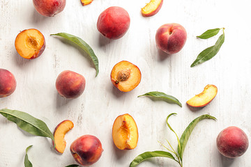 Fresh peaches on white wooden table