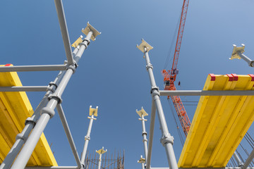 metal concrete structures of the building under construction. scaffolding and supports on a crane background. bottom view