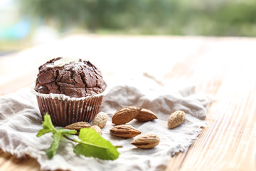 Tasty chocolate muffin on wooden table