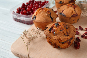 Tasty cranberry muffins on board