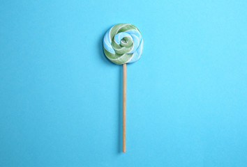 Delicious lollipop on color background