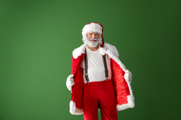 Fototapeta na wymiar Portrait of Santa Claus on color background