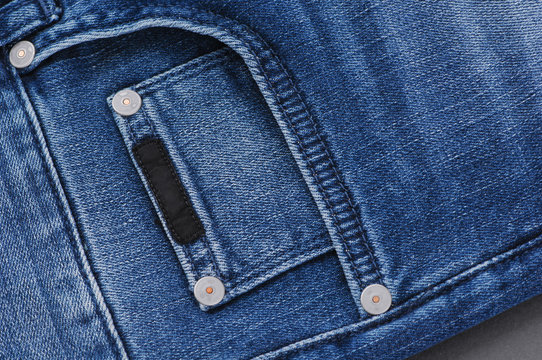 Part Of The Blue Denim Pants With Pockets And Rivets, Close-up