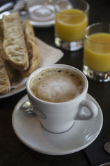 French breakfast with fresh croissants and hot coffee on white table in cafe