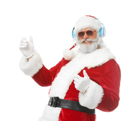 Portrait of Santa Claus listening to music and dancing on white background