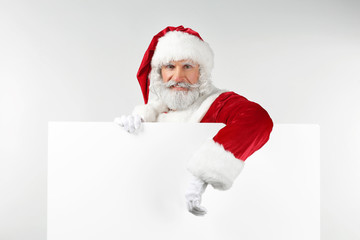 Portrait of Santa Claus with blank poster on white background