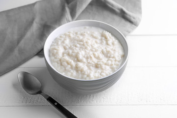 Delicious rice pudding in bowl on white table